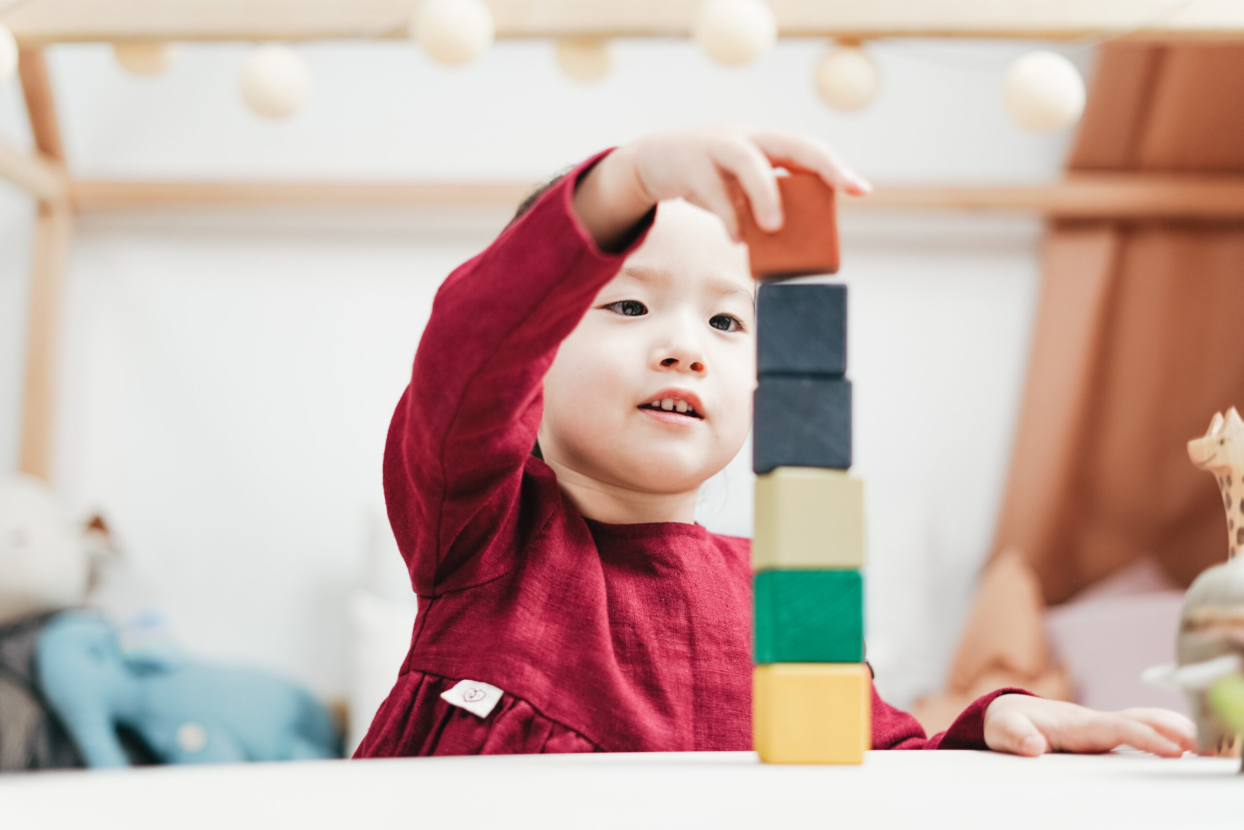 Therapist assisting child during a playful occupational therapy activity.