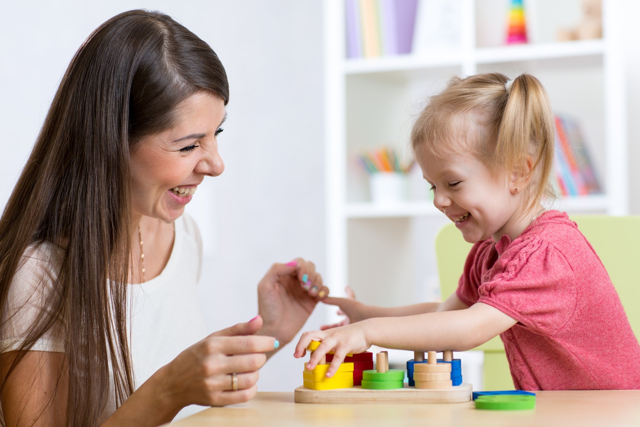 Mother and kid playing educational toys at home